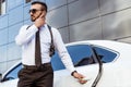 Handsome security guard listening message with security earpiece on street