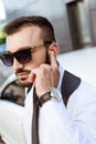 Handsome security guard listening message with security earpiece on street Royalty Free Stock Photo