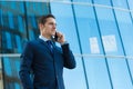 Handsome self confident businessman talks on cellphone Royalty Free Stock Photo