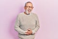 Handsome senior man with beard wearing casual sweater and glasses smiling and laughing hard out loud because funny crazy joke with Royalty Free Stock Photo