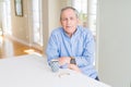 Handsome senior man drinking a cup of coffee at home with a happy and cool smile on face Royalty Free Stock Photo