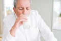 Handsome senior man drinking a glass of fresh milk in the morning Royalty Free Stock Photo