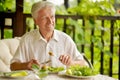 Handsome senior man eating healthy breakfast outdoors Royalty Free Stock Photo