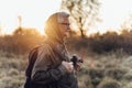 Handsome senior man photographer standing in autumn park and taking pictures with camera Royalty Free Stock Photo