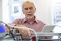 Handsome senior man practicing at running 3D printer