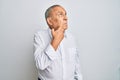 Handsome senior man wearing casual white shirt with hand on chin thinking about question, pensive expression Royalty Free Stock Photo