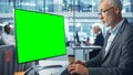 Handsome Senior Specialist Working on Desktop Computer with Green Chroma Key Screen Display in a B Royalty Free Stock Photo