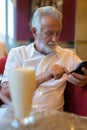 Handsome senior tourist man relaxing inside the coffee shop Royalty Free Stock Photo