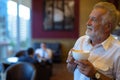 Handsome senior tourist man relaxing inside the coffee shop Royalty Free Stock Photo