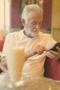 Handsome senior tourist man relaxing inside the coffee shop Royalty Free Stock Photo