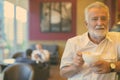 Handsome senior tourist man relaxing inside the coffee shop Royalty Free Stock Photo