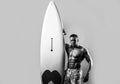 Handsome serfer man with serf board. Male fit with athletic body. Surfboard man with serf board. Surfer with a surfboard