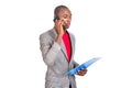Adult businessman talking on mobile phone with clipboard Royalty Free Stock Photo