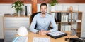 Handsome serious man sit at office boss manager desk