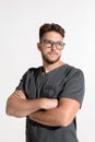 Handsome serious professional young male with arms crossed, physician practitioner in glasses on white studio background Royalty Free Stock Photo