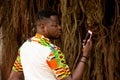 Handsome serious young man looking at his mobile phone outdoors Royalty Free Stock Photo