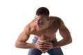 Handsome, serious young man shirtless, holding american football Royalty Free Stock Photo