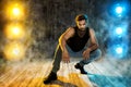 Handsome Sexy Man dancing hip-hop. Modern Dance style Dancer in Nightclub with Blue and Yellow Lights Royalty Free Stock Photo