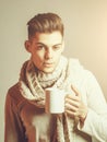 Handsome guy with cup in scarf