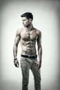 Handsome shirtless athletic young man on white