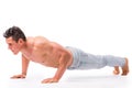 Handsome shirtless bodybuilder doing push-ups in