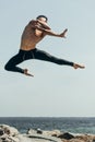 handsome shirtless dancer jumping over