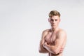 Handsome shirtless fitness man, arms crossed. Studio shot.