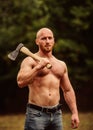 Handsome shirtless man muscular body. Bodybuilding sport concept. Muscular body. Forester with axe. Last man on planet