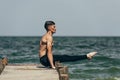 handsome shirtless man practicing yoga and doing arm balance