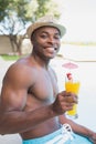 Handsome shirtless man relaxing with cocktail poolside Royalty Free Stock Photo