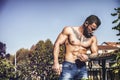 Handsome shirtless muscular young man outdoor