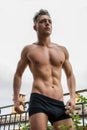 Handsome shirtless muscular young man outdoor