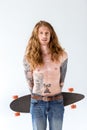 handsome shirtless tattooed sportsman with ginger hair standing with longboard Royalty Free Stock Photo