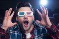 handsome shocked man in 3d glasses watching movie