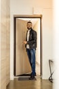 Handsome short-haired bearded man entering the room