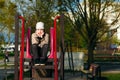 A handsome six year boy is bored sitting on the playground. Place for text Royalty Free Stock Photo