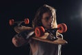 handsome skateboarder with long hair holding longboard Royalty Free Stock Photo