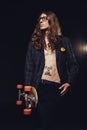 handsome skater with long hair posing with longboard Royalty Free Stock Photo