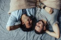 Handsome sleepy man with bristle kissing good night male partner lying in bed Royalty Free Stock Photo