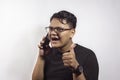 Handsome smart Asian young man calling by smartphone with happy expression agreeing on white background