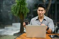 A businessman having an online meeting with his team while remote working at a coffee shop Royalty Free Stock Photo