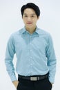 Handsome smiling Asian business man in blue shirt standing with Pick pocket pants arms, on white background. Concept business Royalty Free Stock Photo