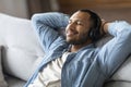 Handsome Smiling Black Man Listening Music In Wireless Headphones At Home Royalty Free Stock Photo