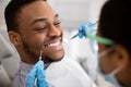 Handsome Smiling Black Man Sitting At Dentist Chair Ready For Check Up