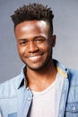 Handsome smiling black man standing by gray background Royalty Free Stock Photo