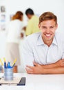 Handsome smiling business man. Portrait of handsome business man smiling with people in background. Royalty Free Stock Photo