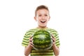 Handsome smiling child boy holding green watermelon fruit Royalty Free Stock Photo