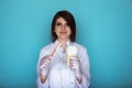 Handsome smiling female dentist holding big fake tooth and toothbrush isolated. Oral care concept. Royalty Free Stock Photo