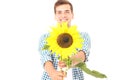 Handsome smiling guy with sunflower isolated on white. Selective focus. Copy space. Summer Royalty Free Stock Photo