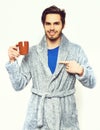 Handsome bearded smiling man with cup in terry bathrobe Royalty Free Stock Photo